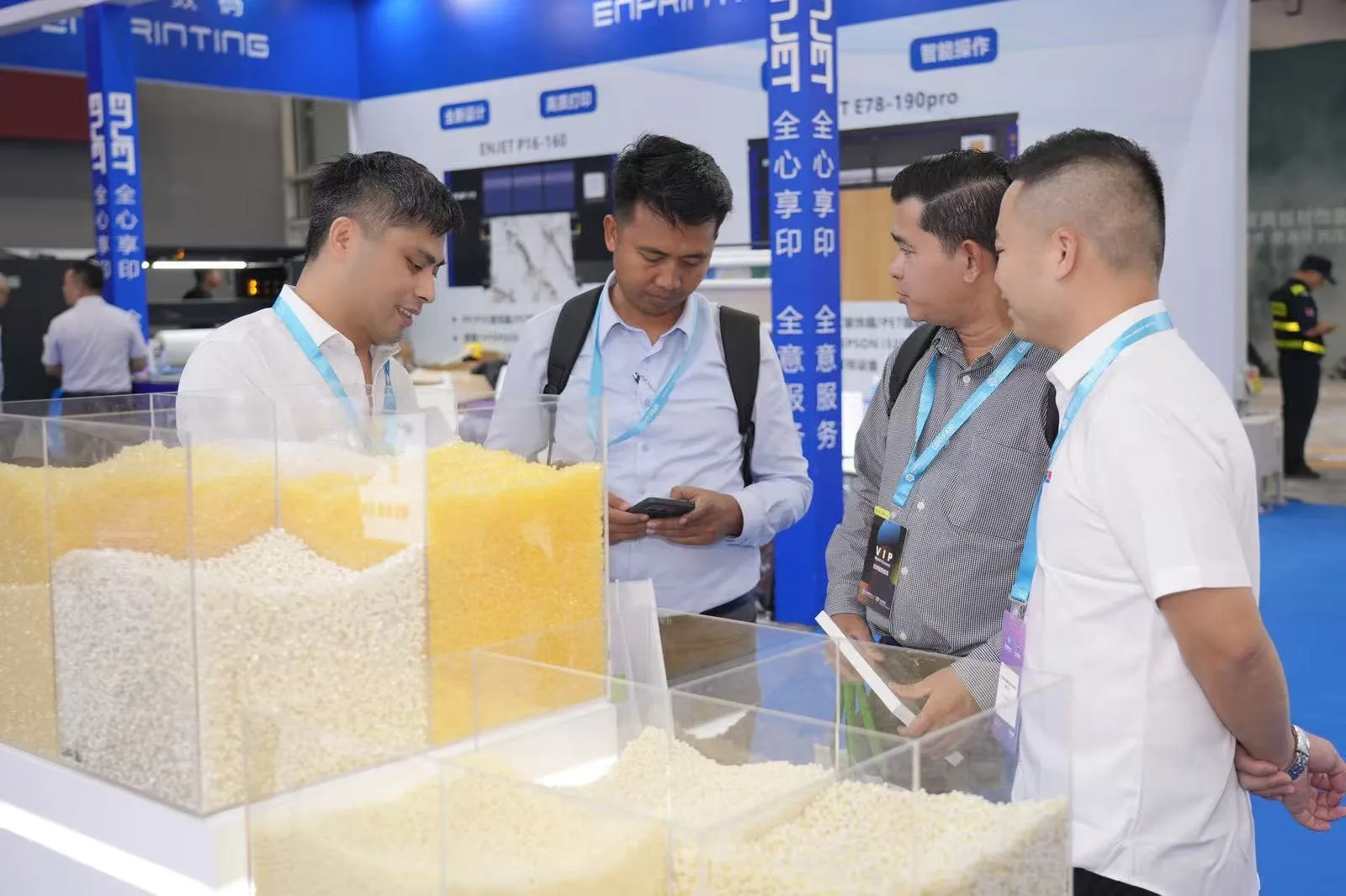 QG Bond team discussing hot melt adhesive samples with exhibition visitors